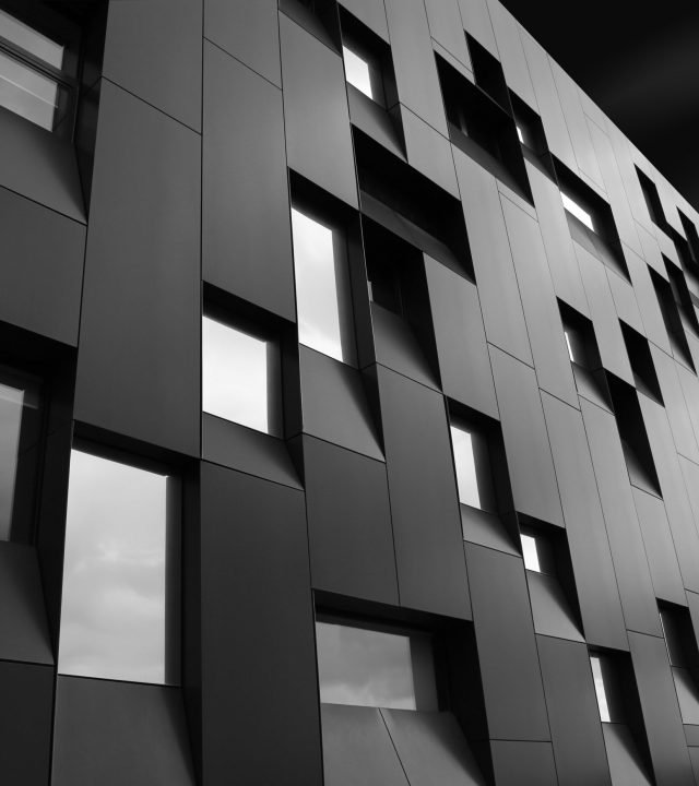 Low angle shot of a creative modern building with outstanding architectural twists A low angle shot of a creative modern building with outstanding architectural twists